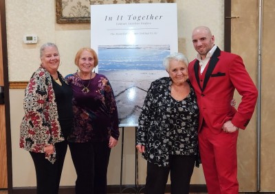 The author, Eckhart Aurelius Hughes (right), with guests at the book release party for In It Together